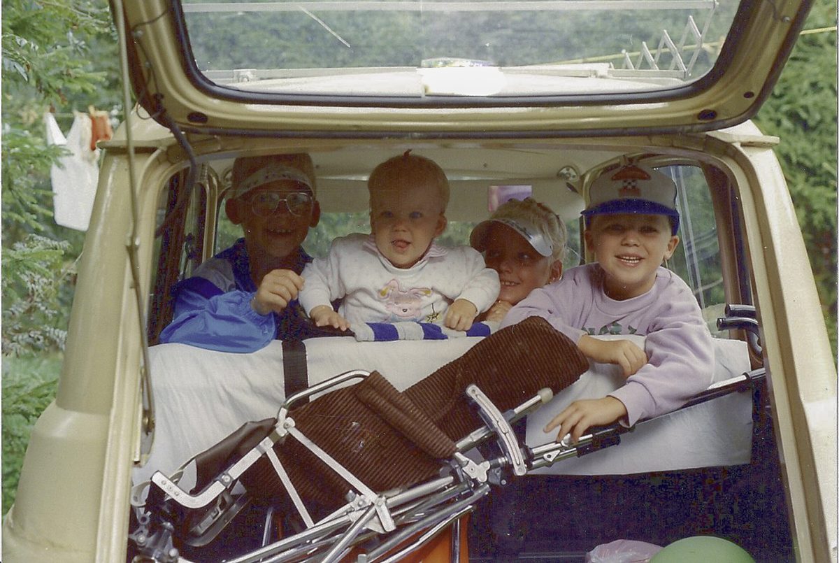 Four children in the back of a vintage station wagon